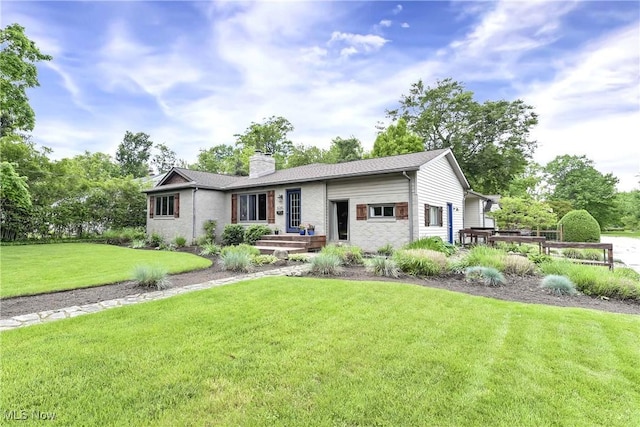4346 Selhurst Rd, North Olmsted, OH 44070 - view of front of property with a chimney, brick siding, and a front lawn