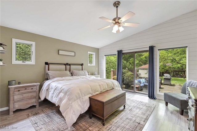 4346 Selhurst Rd, North Olmsted, OH 44070 - bedroom featuring access to exterior, light wood-style flooring, vaulted ceiling, ceiling fan, and wooden walls