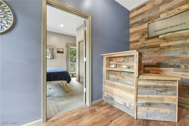 4346 Selhurst Rd, North Olmsted, OH 44070 - hall with wooden walls, wood finished floors, and baseboards