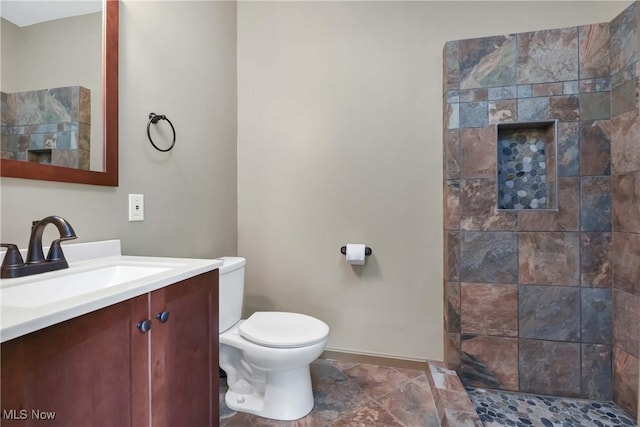 4346 Selhurst Rd, North Olmsted, OH 44070 - full bathroom with a tile shower, toilet, vanity, and baseboards
