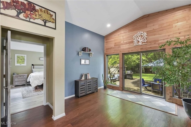 4346 Selhurst Rd, North Olmsted, OH 44070 - doorway to outside with wood walls, high vaulted ceiling, healthy amount of natural light, wood finished floors, and baseboards