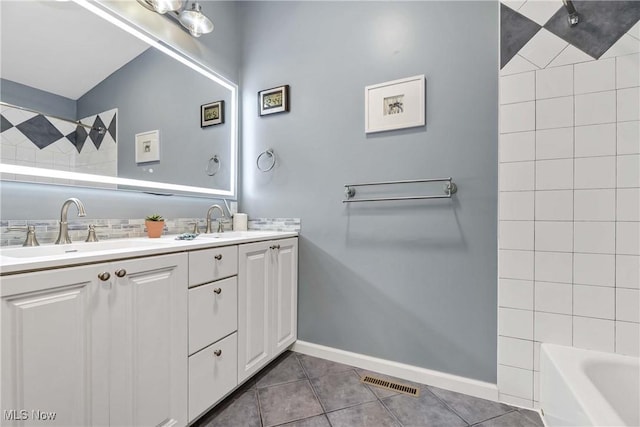 4346 Selhurst Rd, North Olmsted, OH 44070 - bathroom featuring double vanity, tile patterned flooring, baseboards, and shower / tub combination