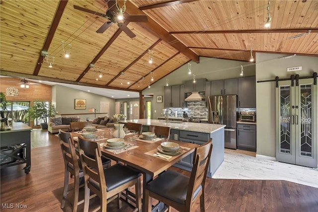 4346 Selhurst Rd, North Olmsted, OH 44070 - dining space featuring ceiling fan, wood ceiling with exposed beams, light wood-style flooring, a barn door, and high vaulted ceiling