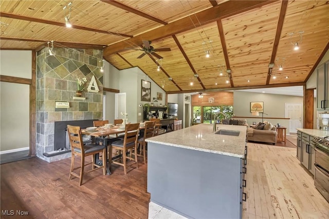 4346 Selhurst Rd, North Olmsted, OH 44070 - kitchen featuring wooden ceiling, a sink, open floor plan, light wood-style flooring, and a fireplace