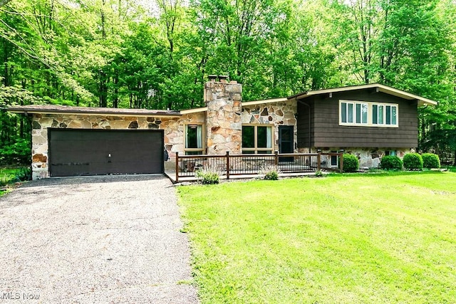 16649 Valley Rd, Chagrin Falls, OH 44023 - view of front of house with an attached garage, stone siding, a chimney, driveway, and a front lawn