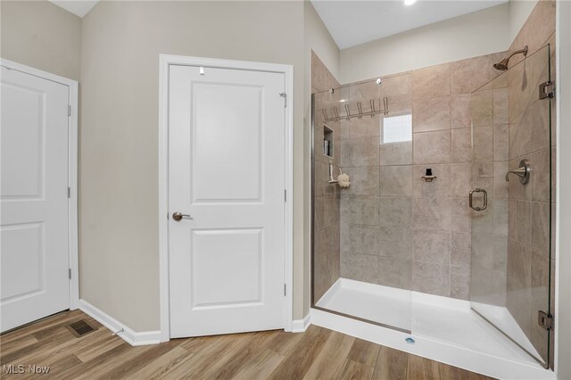 7834 Hunting Lake Dr, Concord, OH 44077 - bathroom with a shower stall, wood finished floors, and baseboards