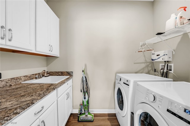 7834 Hunting Lake Dr, Concord, OH 44077 - washroom featuring washer and clothes dryer, cabinet space, baseboards, and dark wood-style flooring