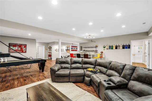 7834 Hunting Lake Dr, Concord, OH 44077 - living area with wood finished floors, recessed lighting, and bar area