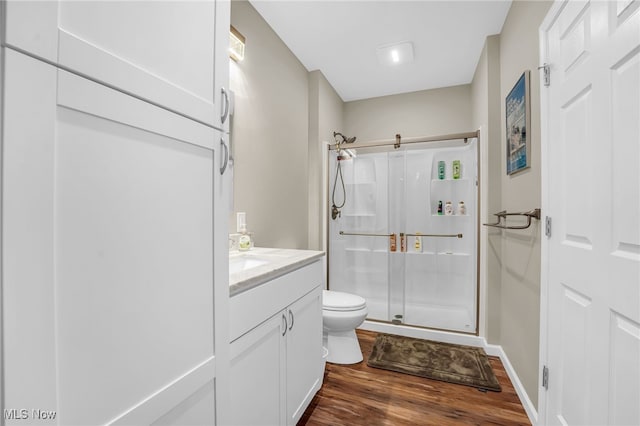 7834 Hunting Lake Dr, Concord, OH 44077 - full bath featuring toilet, a stall shower, wood finished floors, vanity, and baseboards