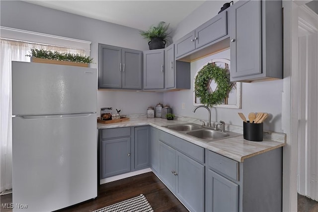 16 Eleanor Ave, Youngstown, OH 44509 - kitchen featuring freestanding refrigerator, gray cabinets, a sink, dark wood finished floors, and light countertops