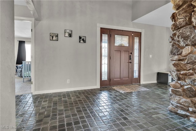 7773 Lutz Ave NW, Massillon, OH 44646 - foyer entrance featuring baseboards, stone tile flooring, and a high ceiling
