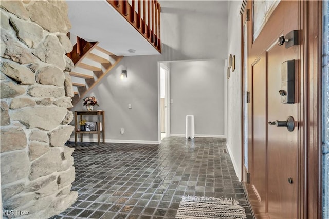 7773 Lutz Ave NW, Massillon, OH 44646 - unfurnished living room featuring a towering ceiling and baseboards