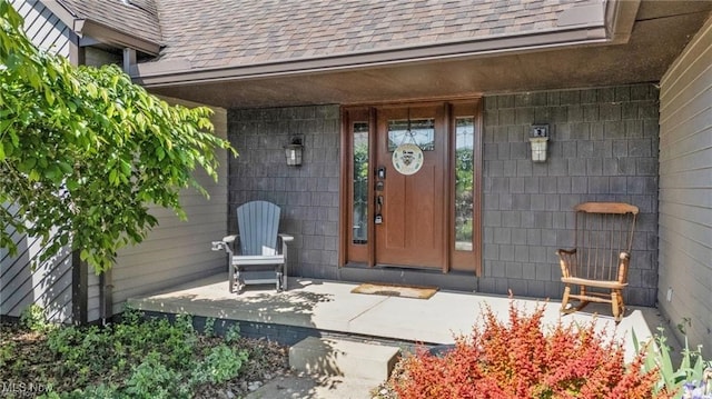7773 Lutz Ave NW, Massillon, OH 44646 - doorway to property with roof with shingles and covered porch