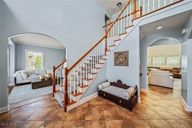 8041 Daisy Hill Ct, Concord, OH 44077 - stairs featuring arched walkways, baseboards, and crown molding