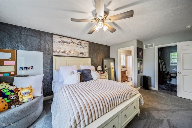8041 Daisy Hill Ct, Concord, OH 44077 - bedroom with dark colored carpet, wallpapered walls, baseboards, a walk in closet, and an accent wall