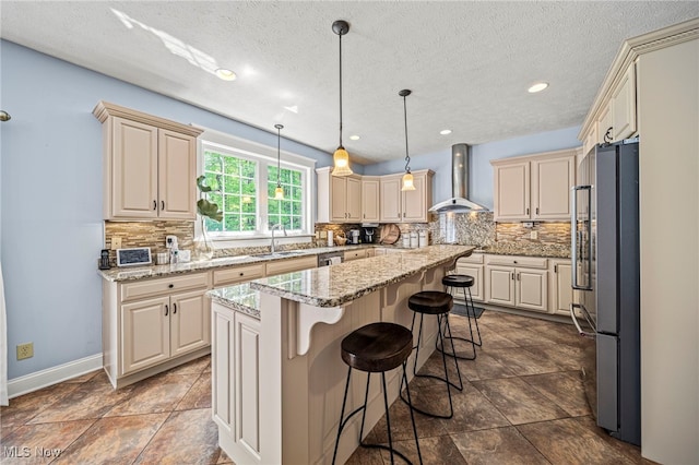8041 Daisy Hill Ct, Concord, OH 44077 - kitchen with wall chimney range hood, freestanding refrigerator, a sink, a kitchen island, and tasteful backsplash