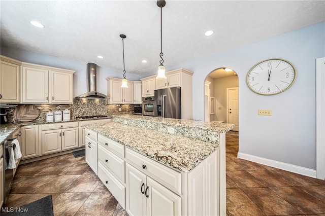 8041 Daisy Hill Ct, Concord, OH 44077 - kitchen with wall chimney range hood, stainless steel appliances, cream cabinetry, arched walkways, and a kitchen island