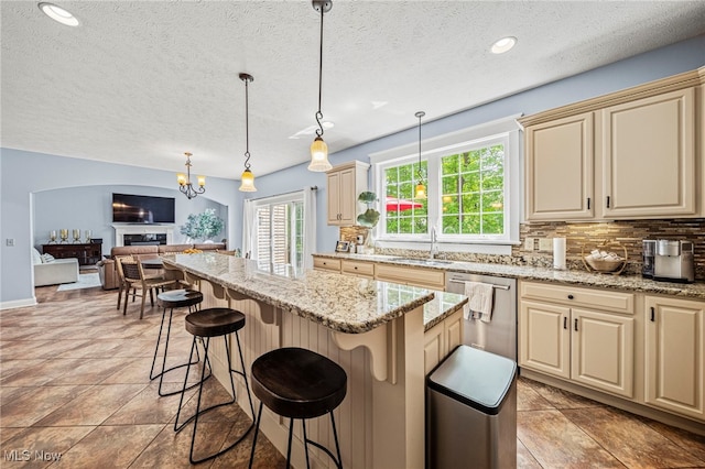8041 Daisy Hill Ct, Concord, OH 44077 - kitchen with cream cabinetry, dishwasher, a sink, tasteful backsplash, and open floor plan