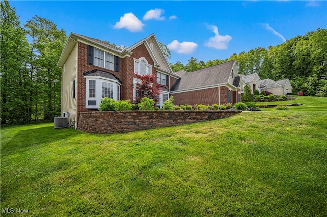 8041 Daisy Hill Ct, Concord, OH 44077 - view of side of property with brick siding, a lawn, and cooling unit