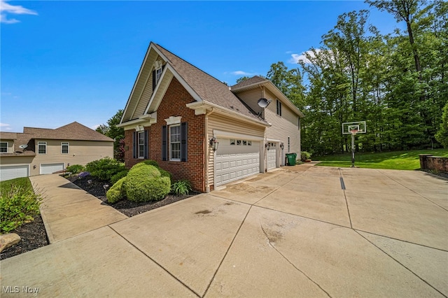 8041 Daisy Hill Ct, Concord, OH 44077 - view of side of home featuring brick siding, driveway, a garage, and roof with shingles