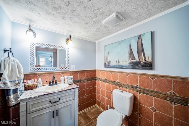 8041 Daisy Hill Ct, Concord, OH 44077 - half bath featuring vanity, tile walls, toilet, a textured ceiling, and wainscoting