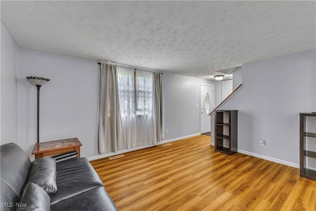 378 Stahl Ave, Cortland, OH 44410 - living room with light wood-type flooring, baseboards, and a textured ceiling