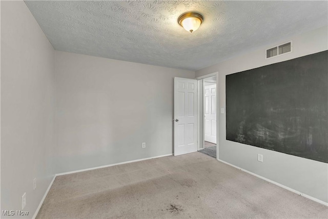 378 Stahl Ave, Cortland, OH 44410 - spare room with baseboards, a textured ceiling, and carpet flooring
