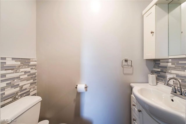 410 Hickory Hollow Dr, Canfield, OH 44406 - bathroom featuring toilet, decorative backsplash, vanity, and tile walls