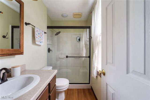 410 Hickory Hollow Dr, Canfield, OH 44406 - bathroom featuring a stall shower, toilet, vanity, and wood finished floors
