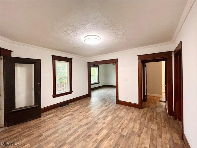616 Mccready Ave, Cadiz, OH 43907 - spare room with light wood-type flooring, baseboards, ornamental molding, and a textured ceiling