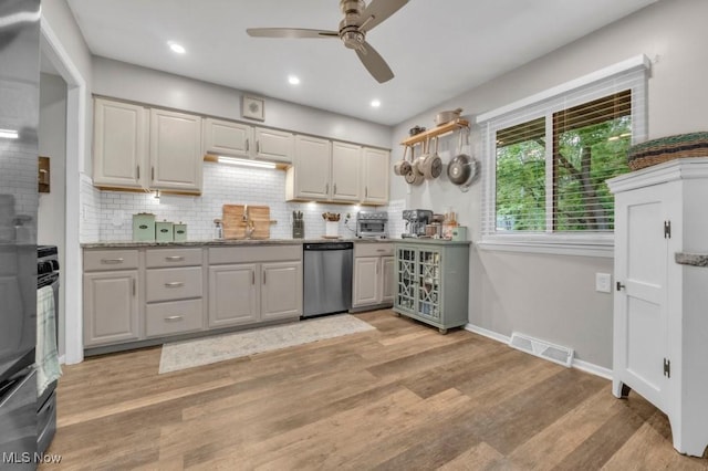 6254 Mackenzie Rd, North Olmsted, OH 44070 - kitchen with dishwasher, a ceiling fan, backsplash, light wood-style flooring, and baseboards