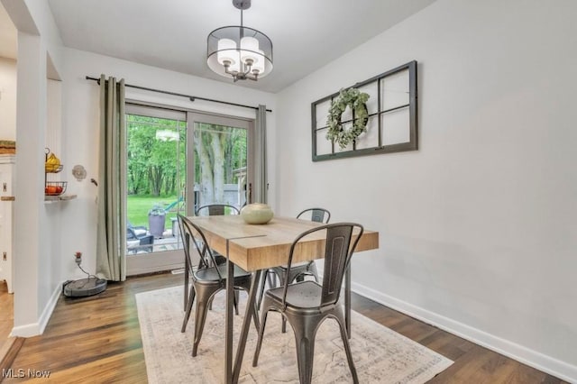 6254 Mackenzie Rd, North Olmsted, OH 44070 - dining space featuring baseboards, wood finished floors, and a chandelier
