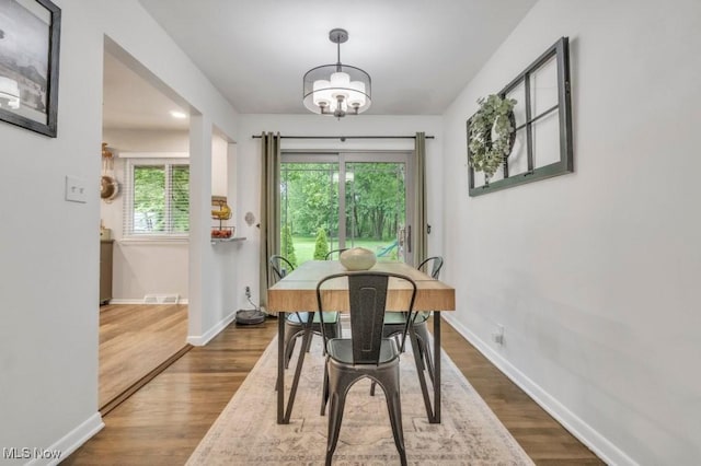 6254 Mackenzie Rd, North Olmsted, OH 44070 - dining area with a chandelier, plenty of natural light, and baseboards