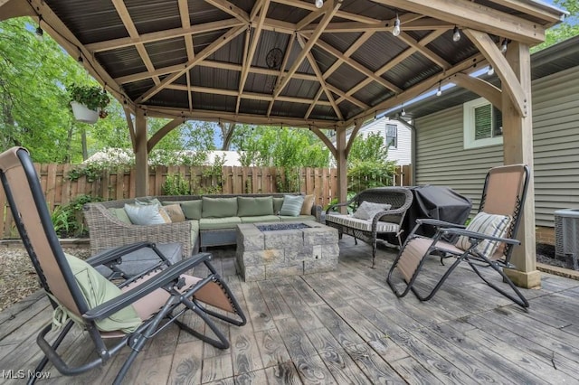 6254 Mackenzie Rd, North Olmsted, OH 44070 - wooden terrace featuring an outdoor living space with a fire pit, a gazebo, a fenced backyard, and cooling unit