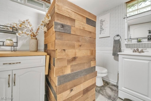 6254 Mackenzie Rd, North Olmsted, OH 44070 - bathroom featuring vanity, toilet, and wainscoting