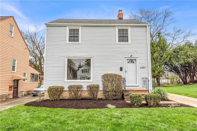 19407 Gardenview Dr, Maple Heights, OH 44137 - view of front facade featuring a front yard and a chimney