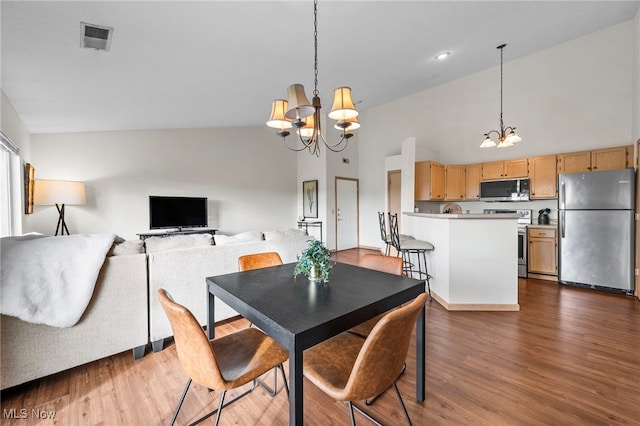 1444 Buckingham Gate Blvd Unit H, Cuyahoga Falls, OH 44221 - dining space with a chandelier, high vaulted ceiling, and dark wood finished floors