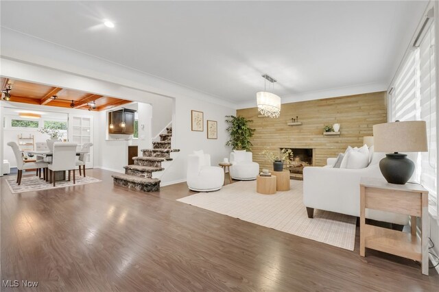 2524 Claver Rd, University Heights, OH 44118 - living room featuring stairs, wood finished floors, a fireplace, wood walls, and beamed ceiling