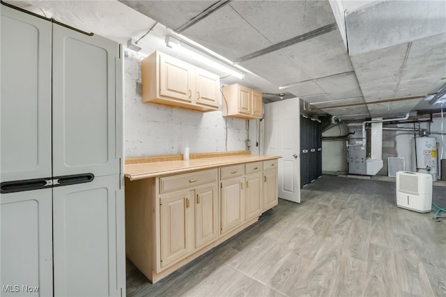 2524 Claver Rd, University Heights, OH 44118 - basement with heating unit, light wood finished floors, gas water heater, and washer / dryer