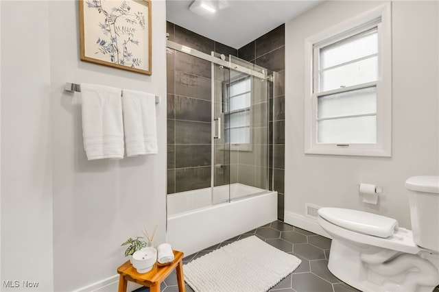 2524 Claver Rd, University Heights, OH 44118 - bathroom with toilet, tile patterned flooring, baseboards, and combined bath / shower with glass door