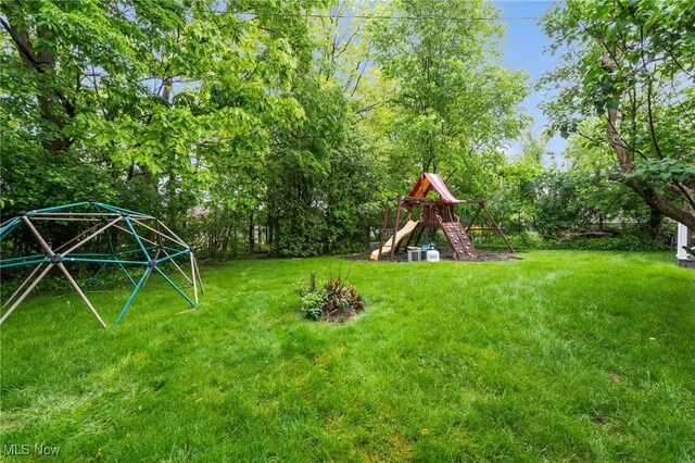 2524 Claver Rd, University Heights, OH 44118 - view of grassy yard with a playground and view of scattered trees