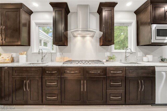 2524 Claver Rd, University Heights, OH 44118 - kitchen featuring wall chimney range hood, stainless steel appliances, a sink, dark brown cabinets, and recessed lighting