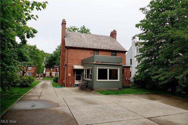 2323 Miramar Blvd, University Heights, OH 44118 - rear view of house featuring brick siding and a chimney