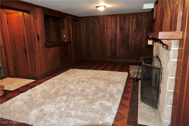 2323 Miramar Blvd, University Heights, OH 44118 - unfurnished living room featuring wooden walls, tile patterned floors, and a stone fireplace