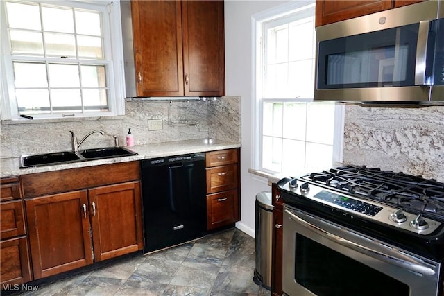 2323 Miramar Blvd, University Heights, OH 44118 - kitchen with stainless steel appliances, a sink, tasteful backsplash, light countertops, and brown cabinets