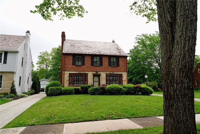 2323 Miramar Blvd, University Heights, OH 44118 - view of front of home featuring a front lawn, brick siding, and a garage