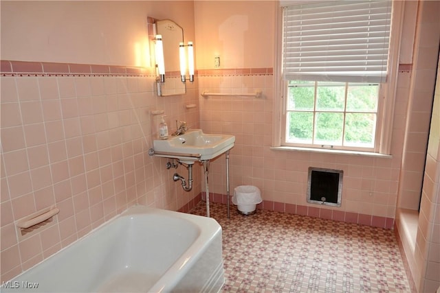 2323 Miramar Blvd, University Heights, OH 44118 - full bathroom featuring a bathtub, tile walls, tile patterned floors, wainscoting, and a sink