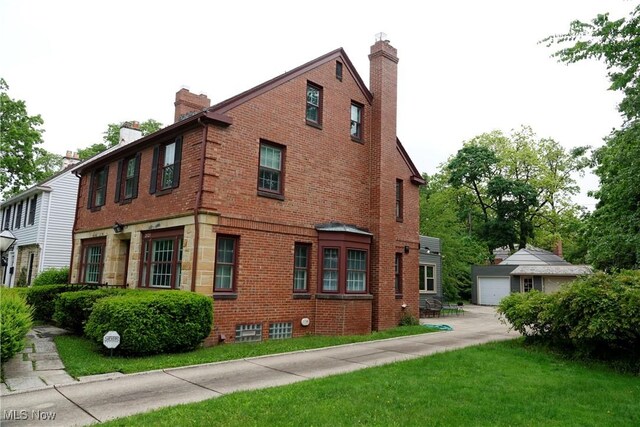 2323 Miramar Blvd, University Heights, OH 44118 - view of side of property featuring brick siding, a chimney, and an outdoor structure