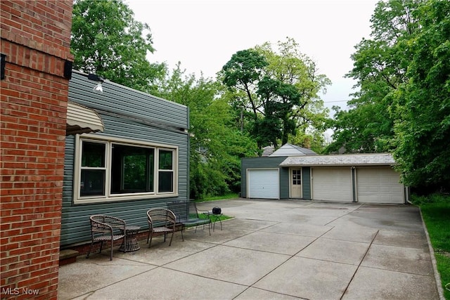 2323 Miramar Blvd, University Heights, OH 44118 - view of patio / terrace featuring a garage and an outbuilding