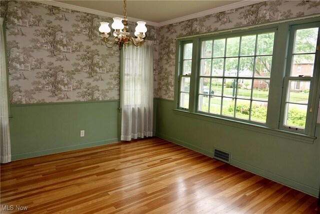 2323 Miramar Blvd, University Heights, OH 44118 - unfurnished room with plenty of natural light, a chandelier, light wood-style flooring, crown molding, and wainscoting